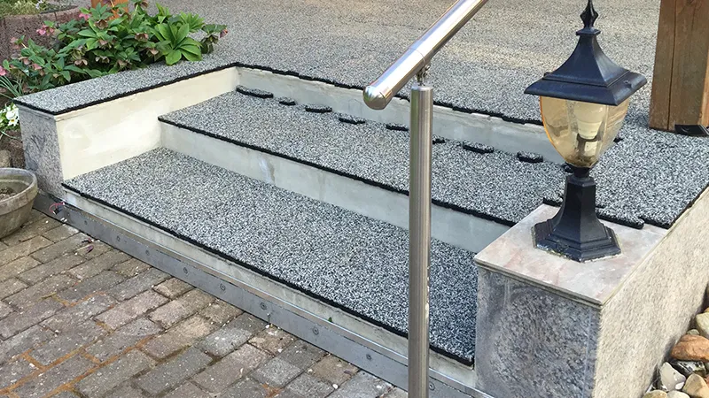 Grey external staircase leads into the garden. WARCO stair covering laid in grey.  Driveway to backyard