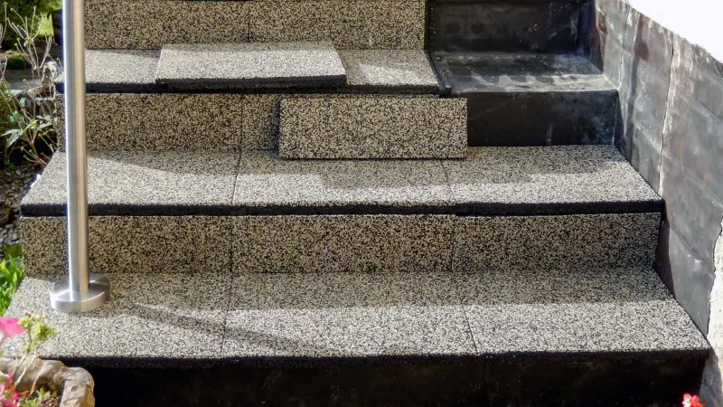 The WARCO decking in the travertine colour design is used to cover the stairs to an elevated terrace, making it attractive and safe.