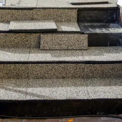 The WARCO decking in the travertine colour design is used to cover the stairs to an elevated terrace, making it attractive and safe.